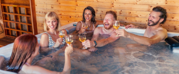 First Time Couples in hot tub raising a toast