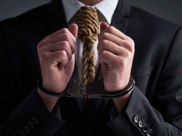 Cuckold husband dressed in business suit and handcuffed