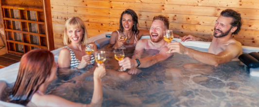 First Time Couples in hot tub raising a toast